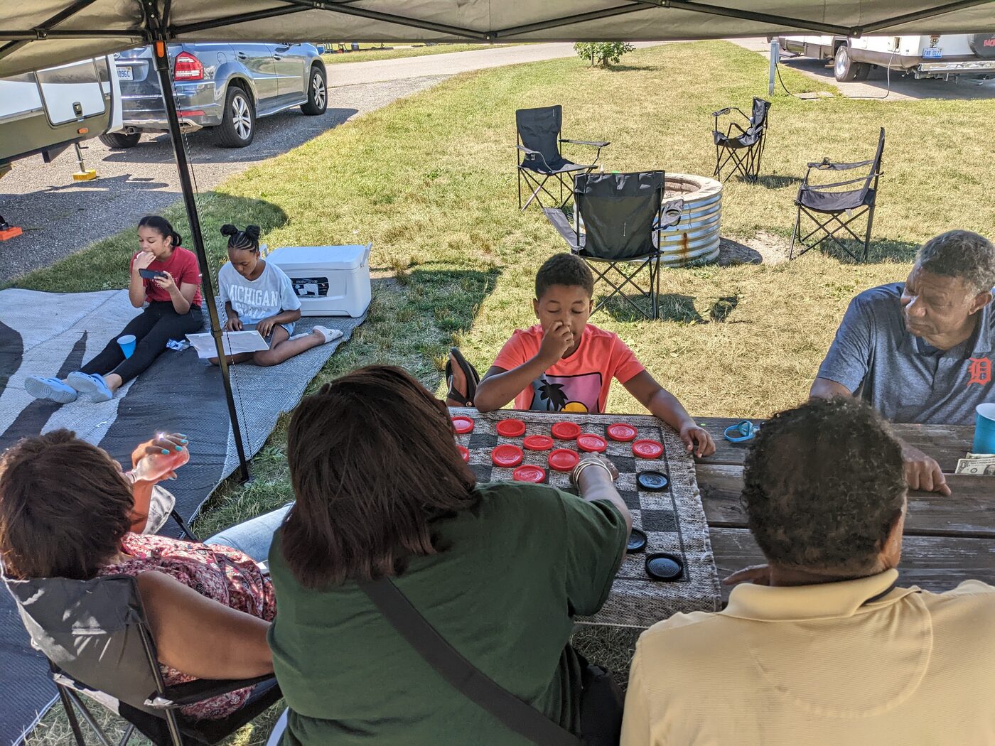 Kids and grandparents together near the campfire ring